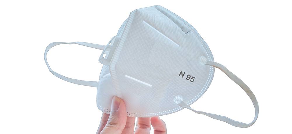 A person holding an N95 mask.