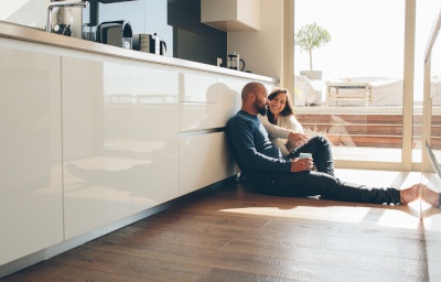 A couple sitting on the floor.